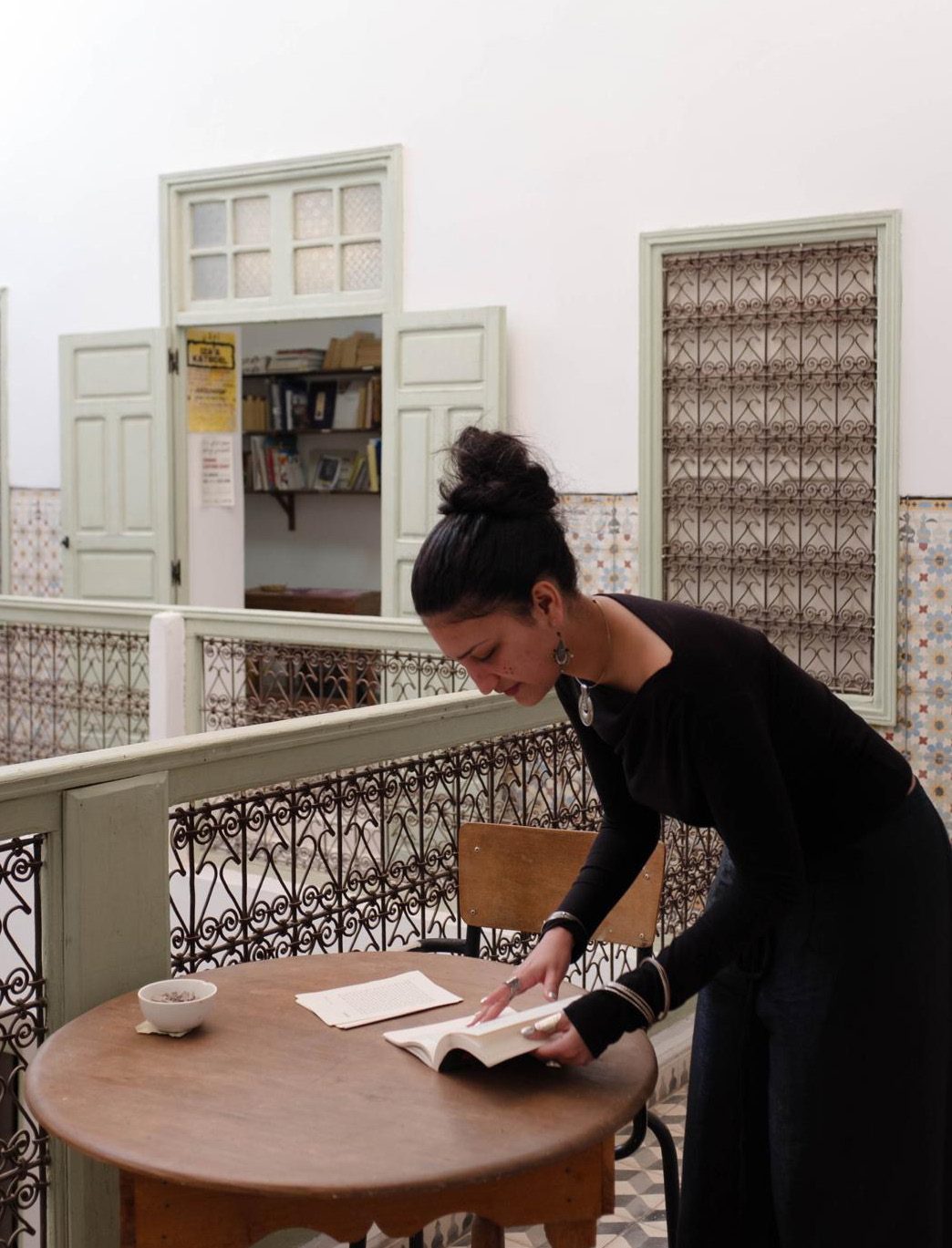 Basma Mansour reading the catalogue at Le 18, Marrakech